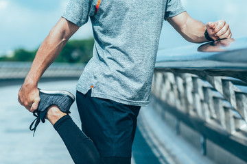 Cropped View of Man Stretching Leg Outside