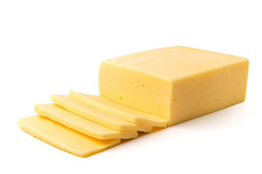 Cheese cut into slices on a white, closeup.