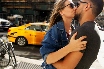 Lovely young couple dressed in casual style walks around Soho and New York city in morning lights