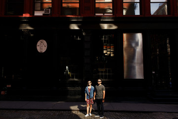 Fototapeta na wymiar Lovely young couple dressed in casual style walks around Soho and New York city in morning lights