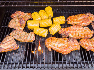 A gas barbeque grill with meat on