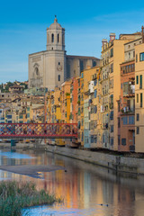 Fototapeta na wymiar Colorful river-front houses lining the Onyar river, mostly built on top of old medieval defense walls, Girona, Catalonia, Spain