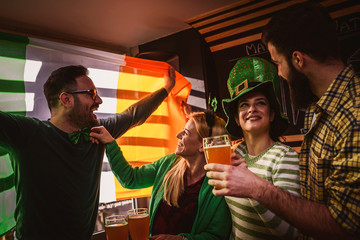 Group of Friends Celebrating St Patrick's Day in Beer Pub