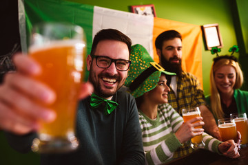 Group of Friends Celebrating St Patrick's Day in Beer Pub