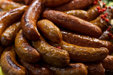 Freshly cooked sausages on a grill close-up. A background of sausages cooked on charcoal.
