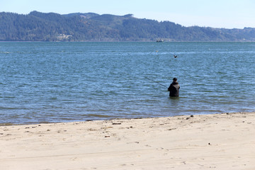 Man surf fishing in the river.