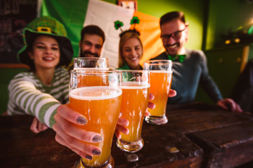 Group of Friends Celebrating St Patrick's Day in Beer Pub