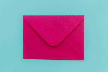 Pink envelope for valentines day on blue background