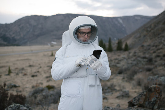 Cosmonaut standing with a phone