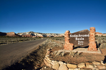 The Entrance of Sandstone Kodachrome Basin Sign State Park with Sign beside of the Road within a Natural Desert Landscape, Southwest America