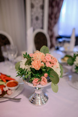 Silver vase with beautiful orange roses