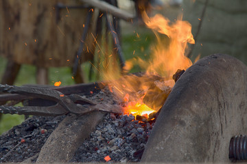 Village Blacksmith near bellows and anvil at work