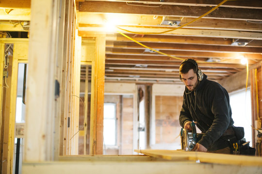 Carpenter man working on jobsite with skill saw