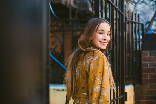 Woman Standing In Front Of Apartment Building