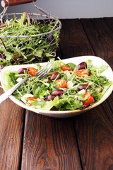 Salad with cheese and fresh vegetables and arugula. Greek salad.