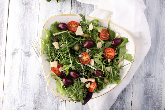 Salad with cheese and fresh vegetables and arugula. Greek salad.