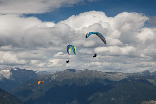 paraglider flying over the Alps from Kronplatz peak
