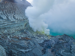 Aerial view from drone to Kawah Ijen volcano crater with sulfur fume. Banyuwangi, East Java, Indonesia