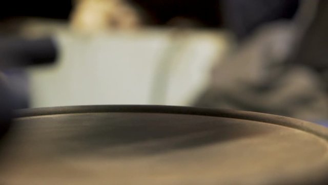 Drummer's fingers beating on an electric snare drum.