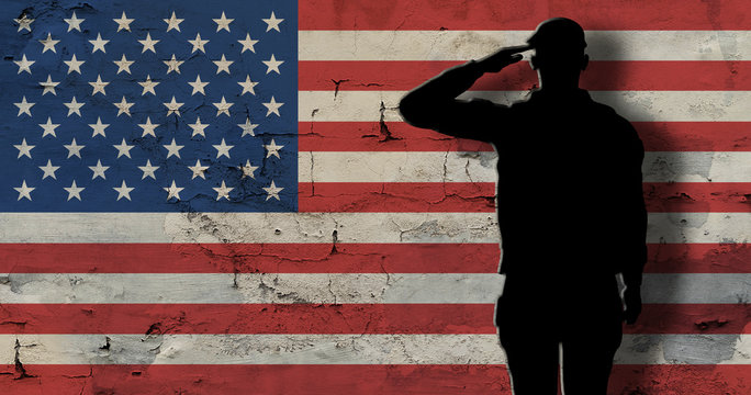 Silhouette soldier against background an old stone wall with flag of the USA