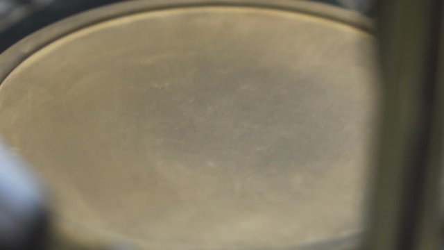 Close up of an electric floor drum, drum stick beating on it.