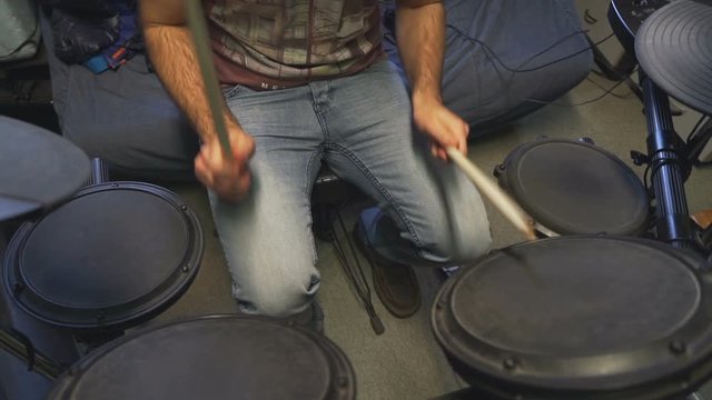 Drummer jamming on his electric drums in slow motion.