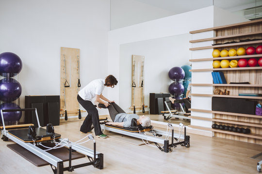 Senior Woman Doing Exercise With Physician