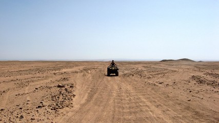 Obraz na płótnie Canvas Quad biking on a desert