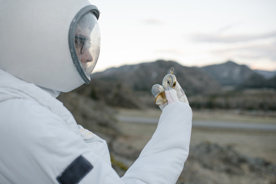 Astronaut looking at&Atilde;&brvbar;compass