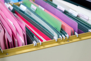 Closeup - Files document of hanging file folders in a drawer in a whole pile of full papers, at work office Bangkok Thailand Business Concept 