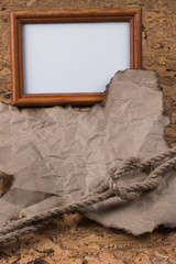 Part of the old burnt parchment and a knot of hemp rope lying on the Old wooden table. A place for...