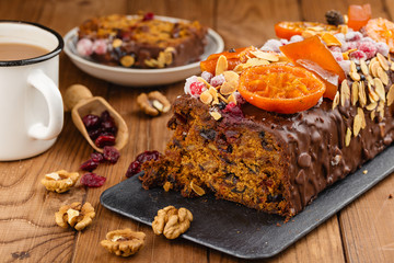 Cut traditional christmas fruit cake pudding in chocolate glaze