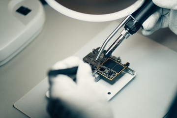 Man repairing smartphone.