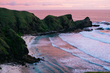 Purple, pink sunset sky over a secluded ideal beach