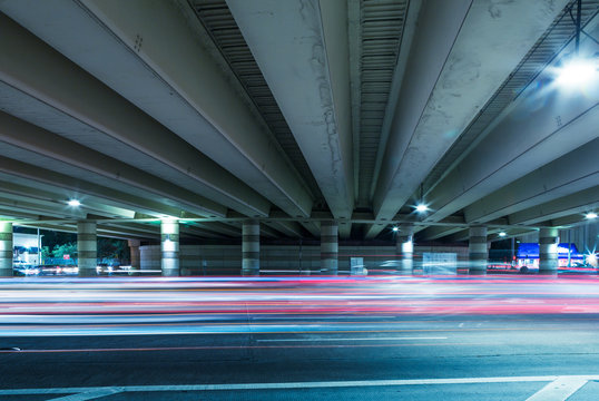 light trails of cars through overpass