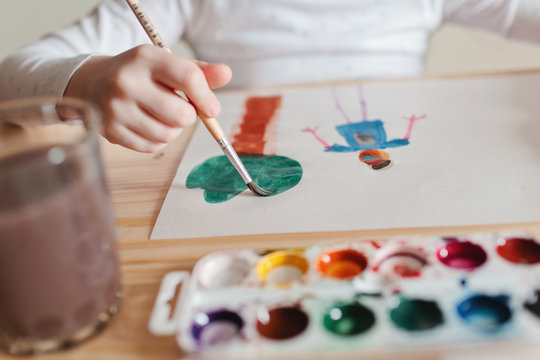 Cute little preschooler child drawing at home