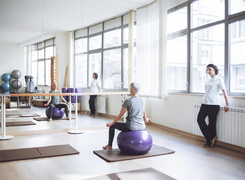 Senior Woman Doing Exercise With Pilates Ball