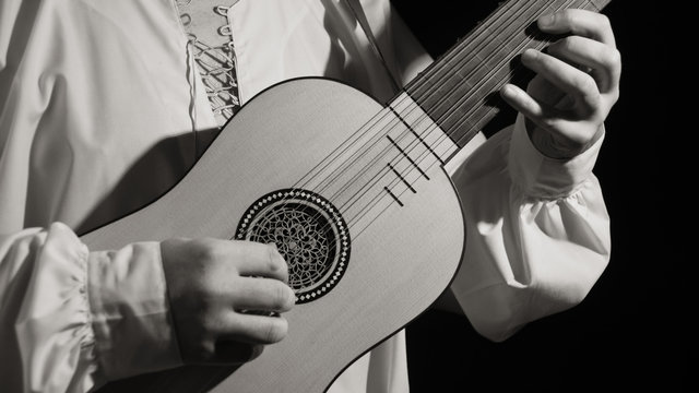 Man playing spanish renaissance instrument vihuela de mano
