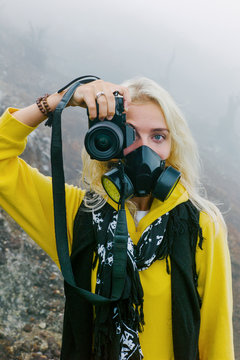 Young female taking photo on volcano