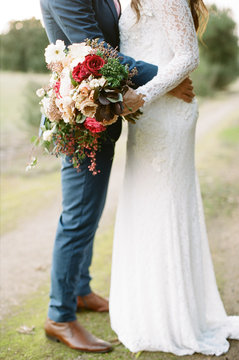 Married couple, bride holding bouquet