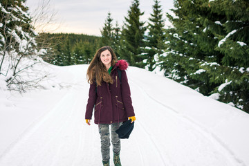 Hipster girl walking on the snowy mountainmi