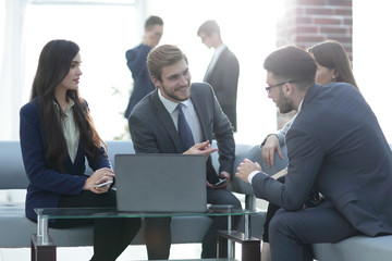 Beautiful business people are using gadgets, talking and smiling