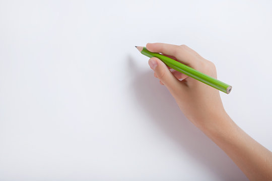 The child's hand with a pencil