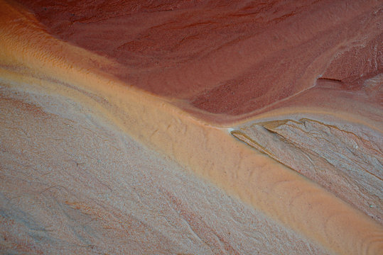 Patterns on wet red sand