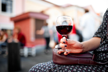 Wine glass with red wine in hand