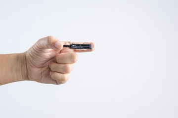 Hand holding black USB memory or storage card reader stick
