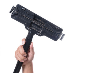Hand holding head of sweeper cleaning device of vacuum cleaner