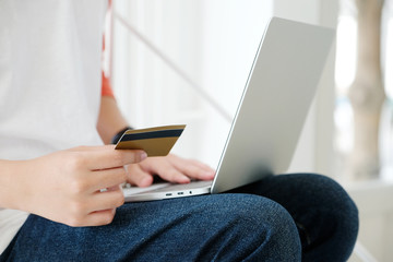 Man holding credit card and using laptop computer to shopping on line, business and technology concept, digital marketing, casual lifestyle