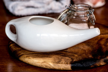 neti pot, ayurvedic tools for cleaning nose with water and pink hymalaian salt