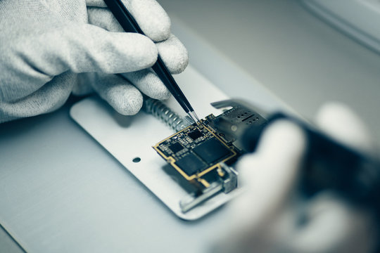 Man repairing smartphone.